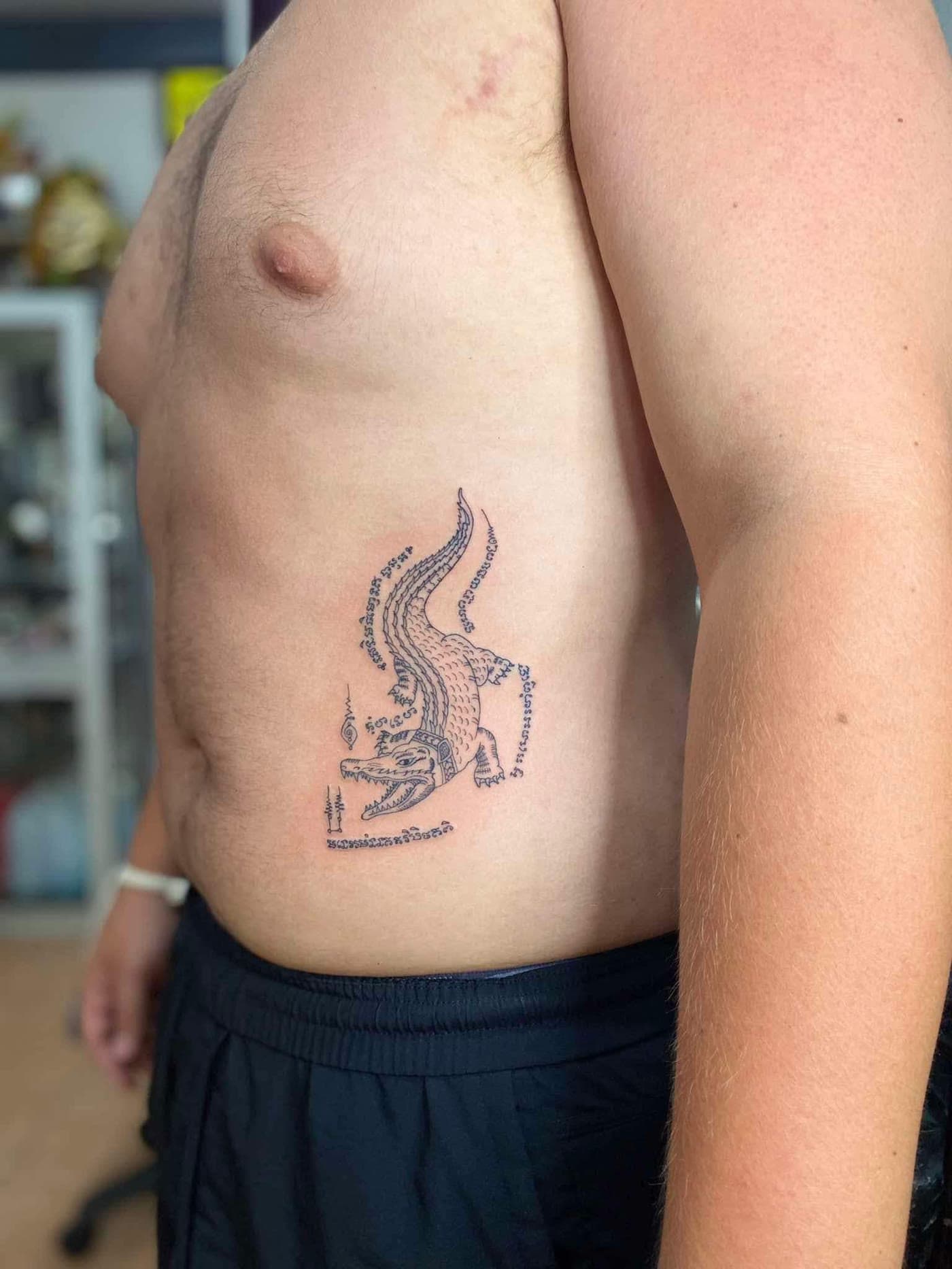 Crocodile Sak Yant along the ribs